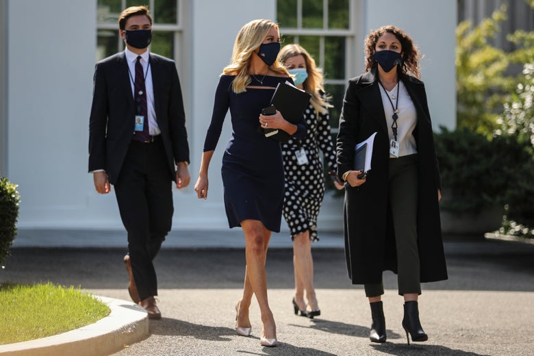 McEnany and three others walking and wearing masks