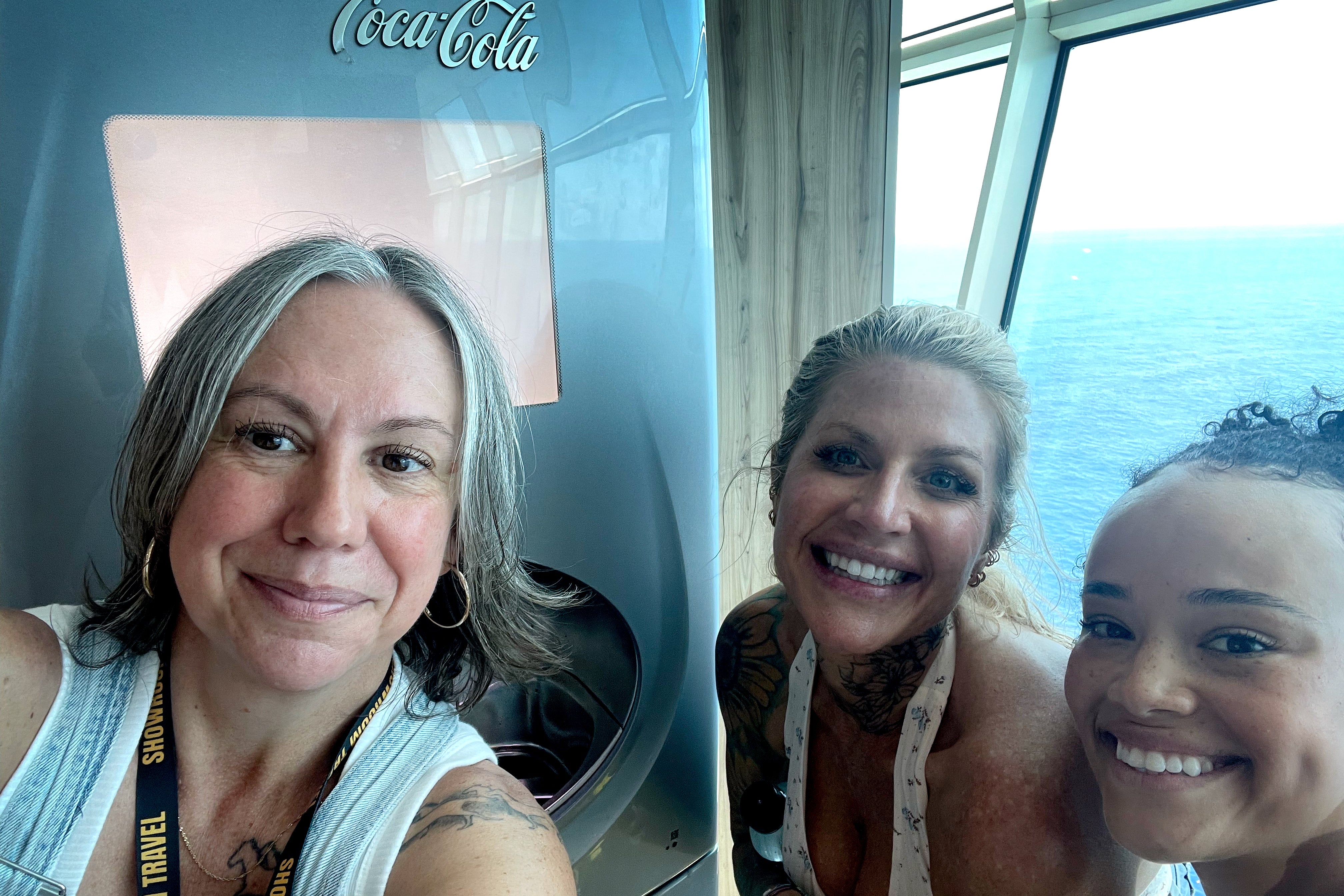 The author smiling with two former Survivor contestants on the cruise ship.