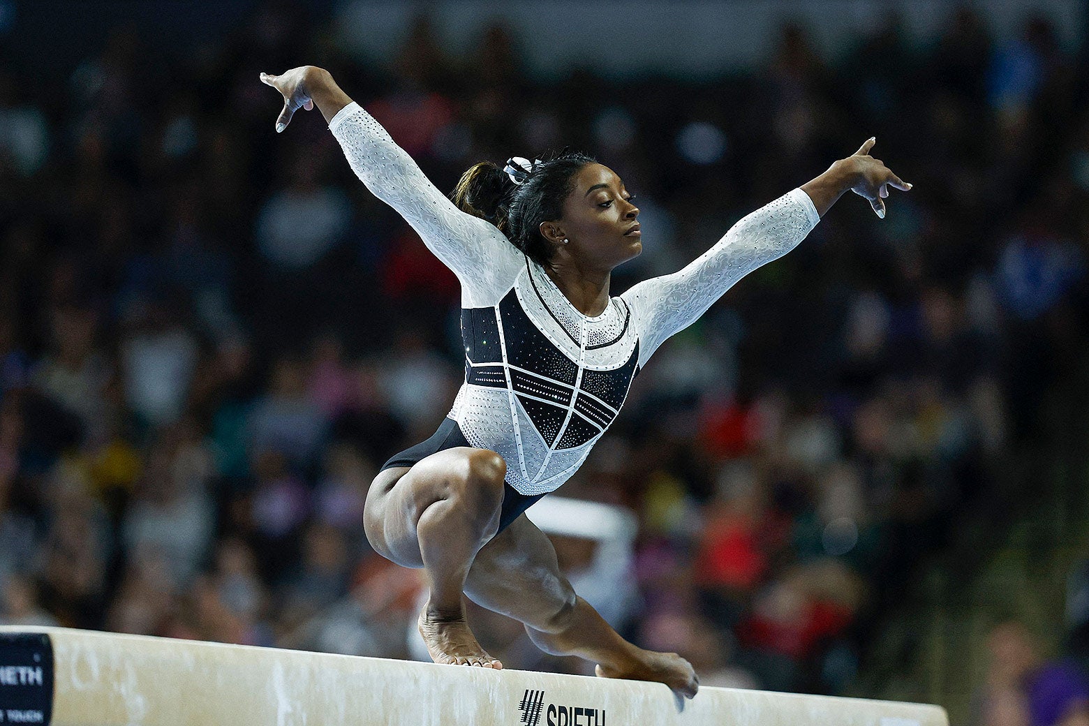 Simone Biles looks graceful and triumphant on the balance beam.