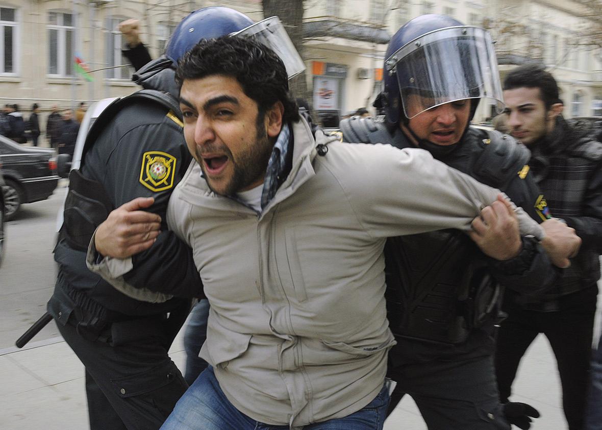 Azeri riot policemen detain protestors in central Baku on Januar,Azeri riot policemen detain protestors in central Baku on January 26, 2013. 
