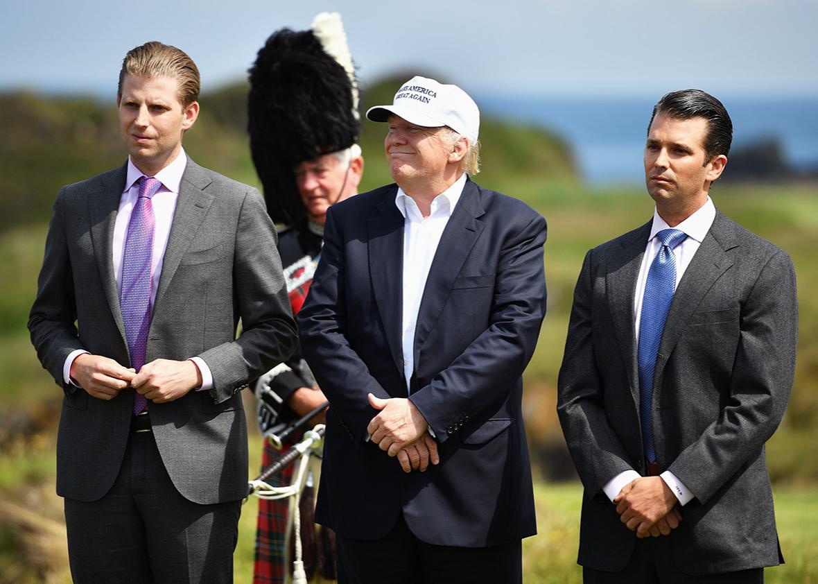 Presumptive Republican nominee for US president Donald Trump stands with his two sons Donald Trump Jr., Eric Trump,following a press conference on the 9th tee at his Trump Turnberry Resort on June 24, 2016 in Ayr, Scotland. 