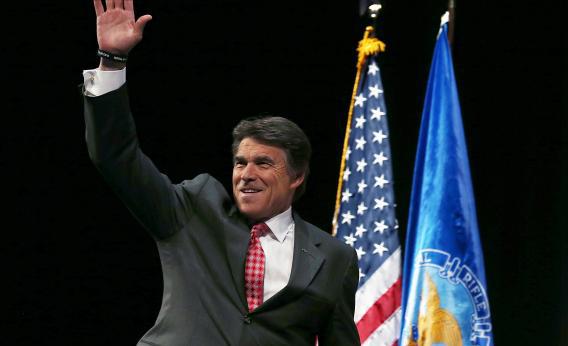 Texas Gov. Rick Perry waves before speaking during the 2013 NRA Annual Meeting and Exhibits at the George R. Brown Convention Center, May 3, 2013, in Houston.