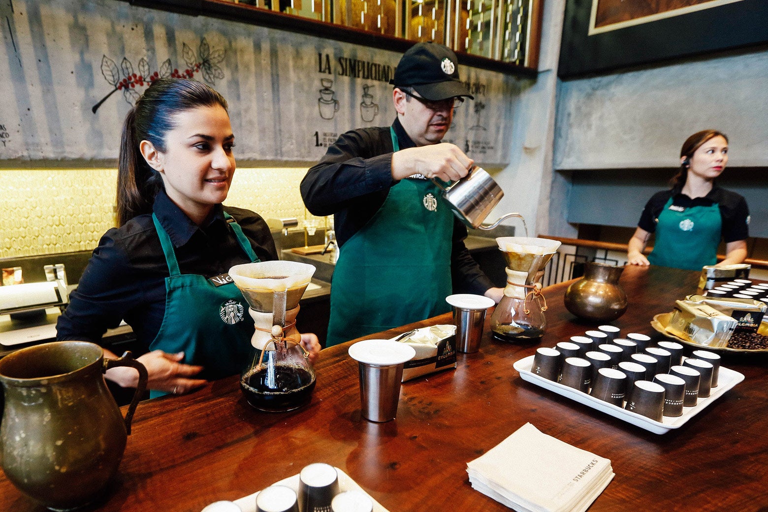 Workers prepare coffee during the inauguration of the first Starbucks in Bogota, Colombia on July 16, 2014.