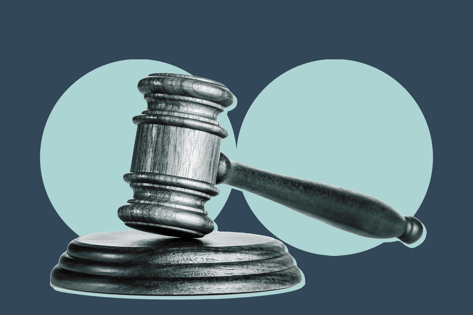A gavel in front of two blue circles.