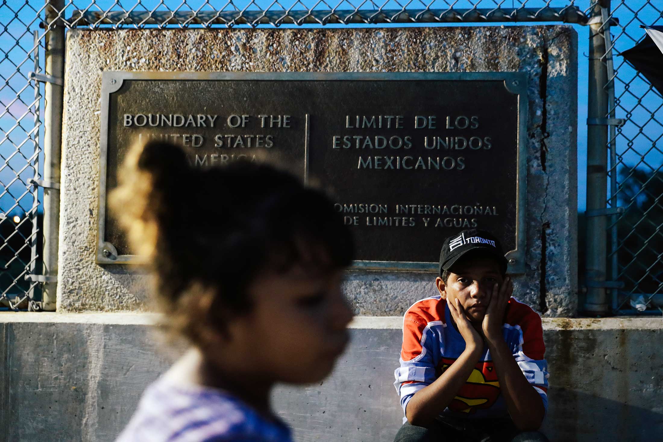 Honduran children seeking asylum wait on the Mexican side of the border near Brownsville, Texas, on Tuesday.