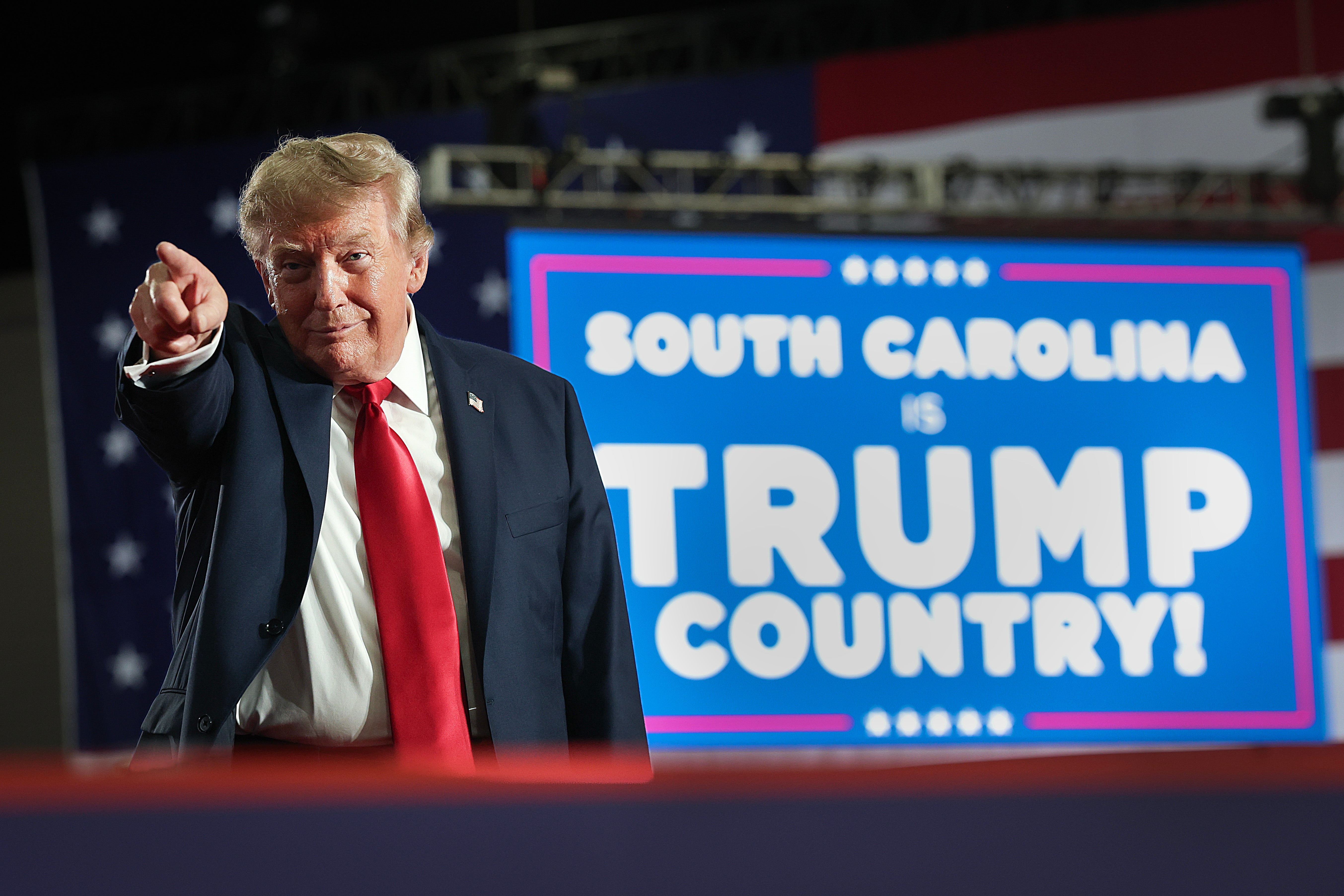 Trump appears in front of a sign that reads "South Carolina is Trump Country!"