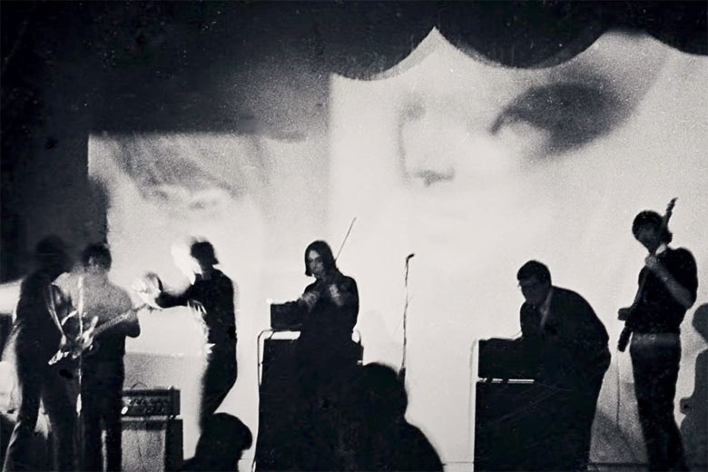 A band stands onstage in a black-and-white image from the documentary.