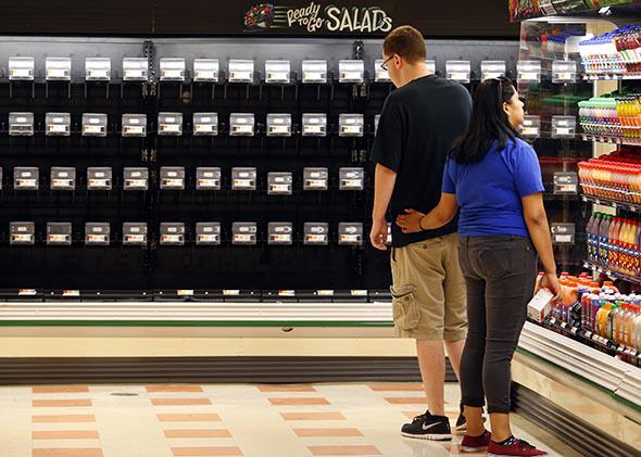 Customers look at limited options inside the produce section at the Market Basket in Tewksbury, Mass. on July 21, 2014. 