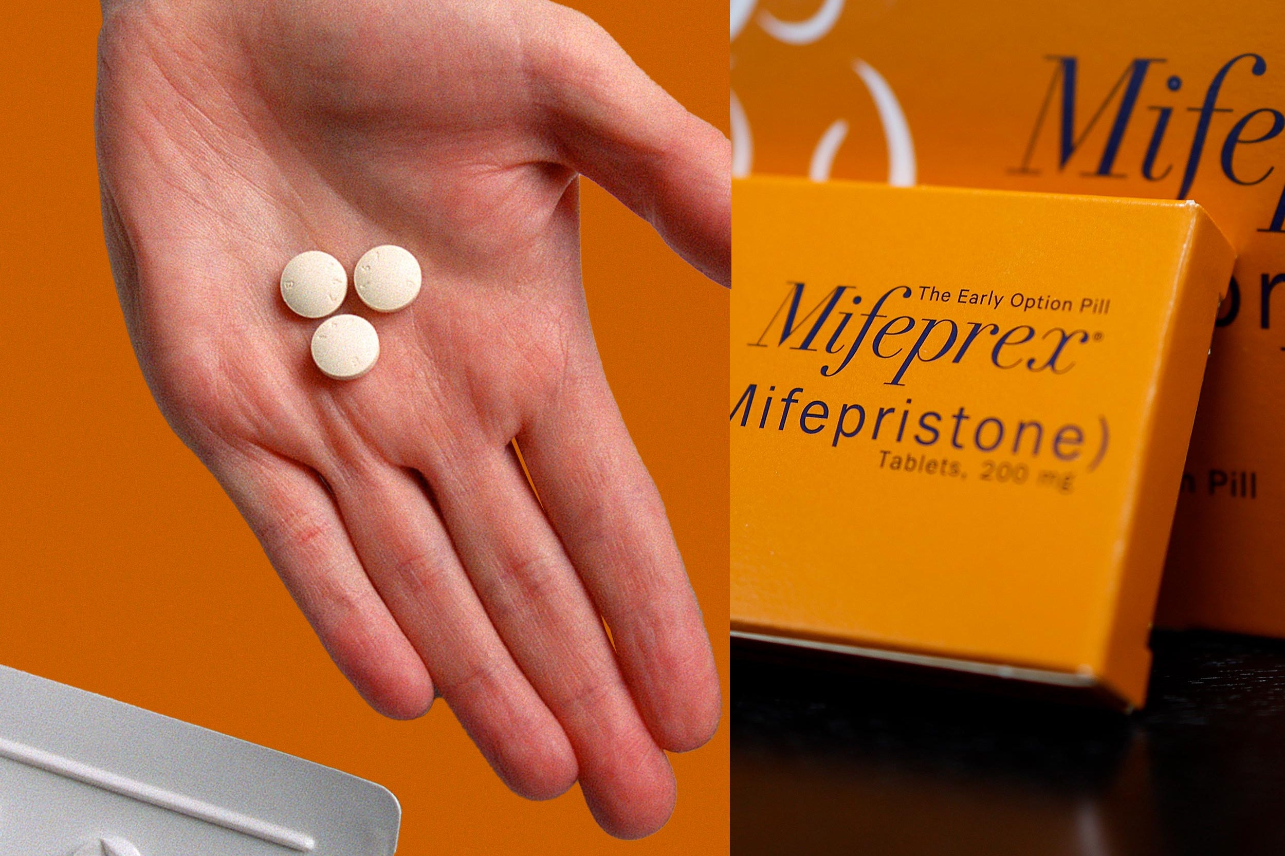 Una mano che tiene pillole di mifepristone.