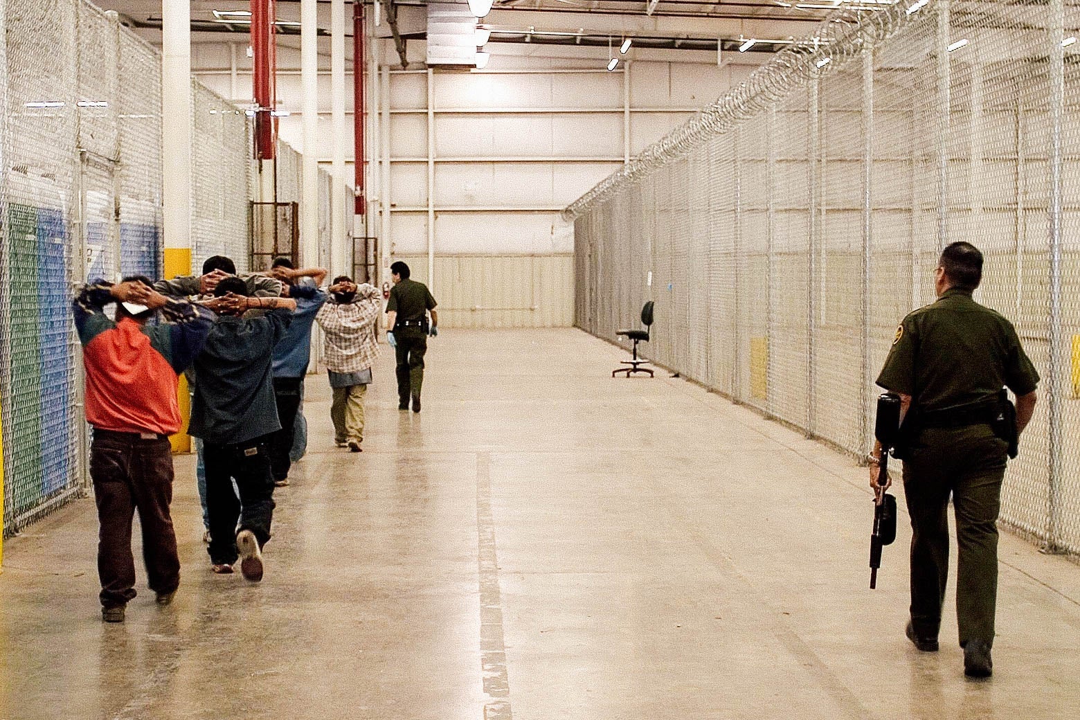 Migrants being placed in a holding facility before being returned to Mexico.