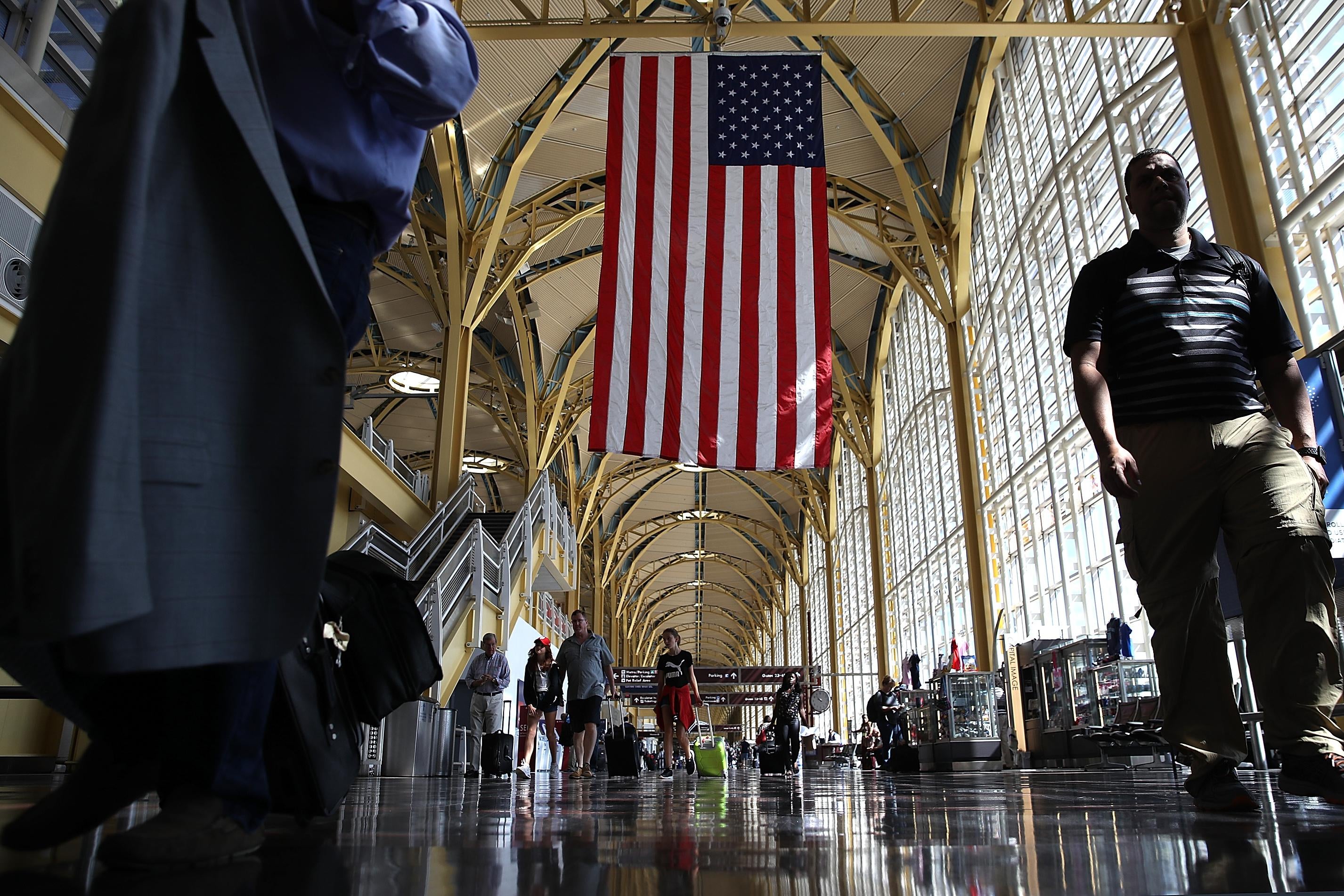 Travelers walk to their gates in the concourse of Reagan National Airport in Washington.