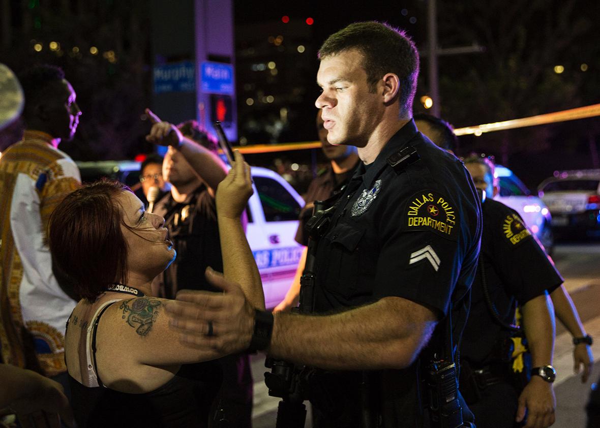 Police attempt to calm the crowd as someone is arrested following the sniper shooting in Dallas on Thursday.