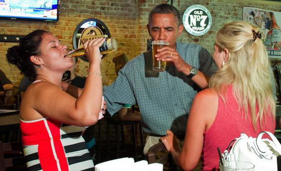 President Obama shares a beer with Suzanne Woods, right, and Jennifer Klanac.