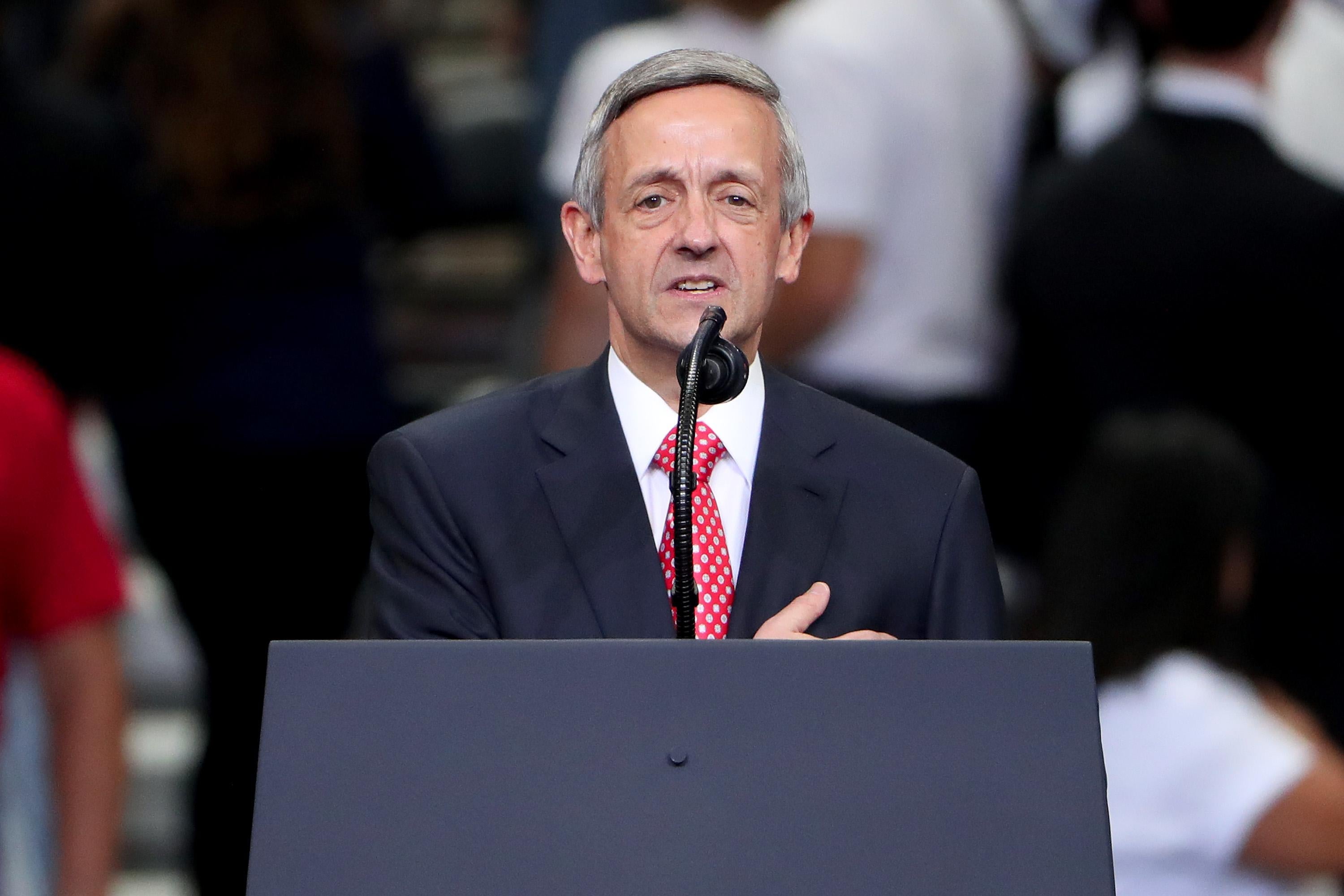 Robert Jeffress stands in front a lectern, speaking into a microphone.