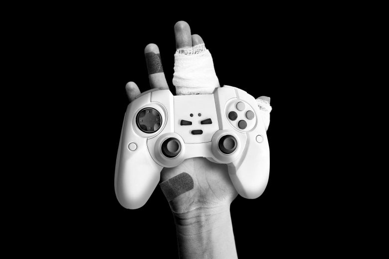 A hand covered in bandages holding out a game controller