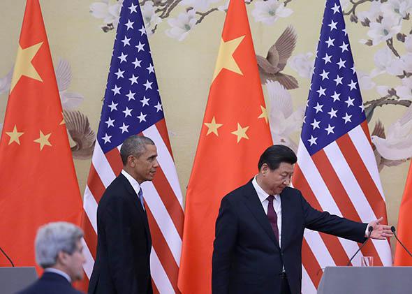 Chinese President Xi Jinping and President Obama walk on stage before their press conference announcing a climate deal at the Great Hall of People on Nov. 12, 2014, in Beijing
