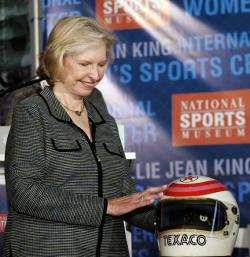 Janet Guthrie, the first woman to earn a starting spot in the Indianapolis 500 and the Daytona 500 in 1977, looks at her helmet.