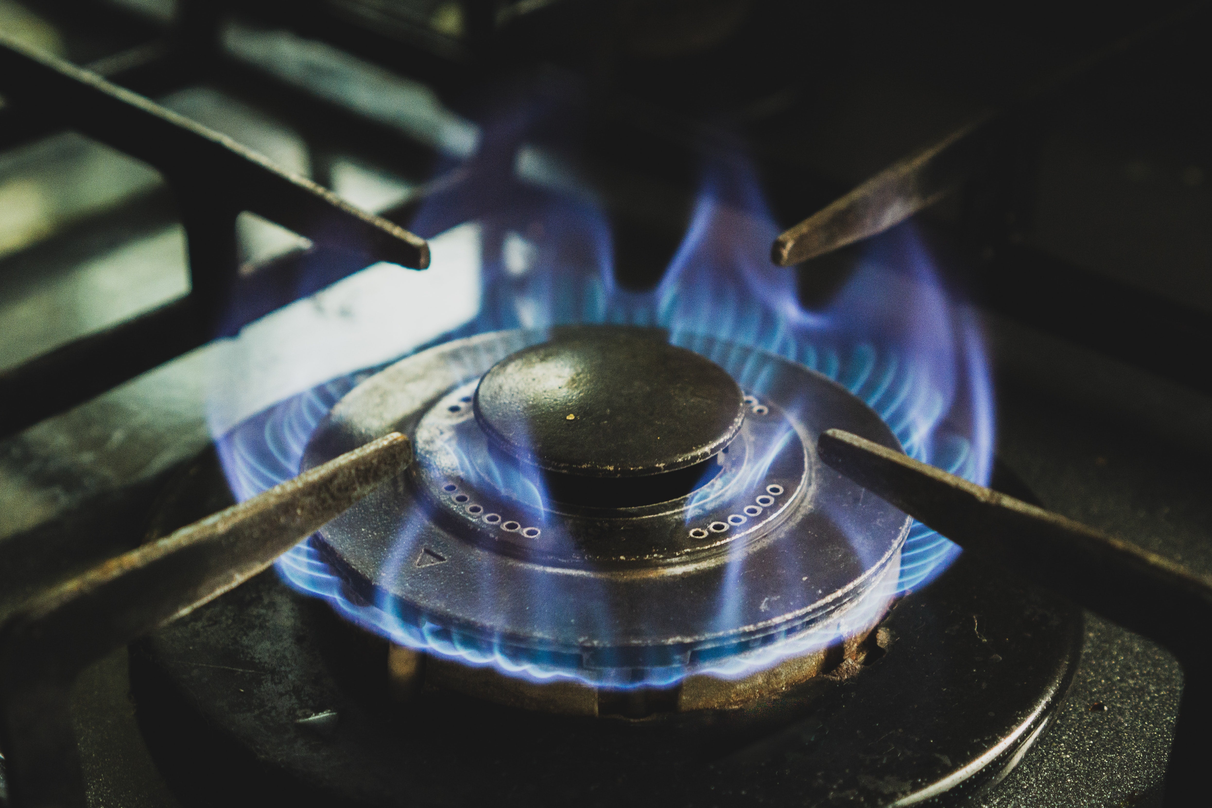 A gas burner lit on a stove.