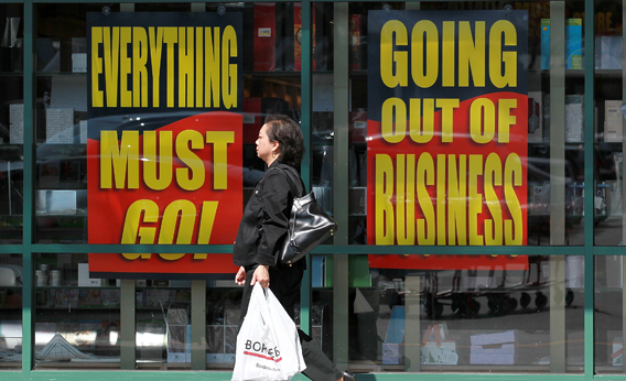 A Borders Books customer walks by signs advertising a going out of business sale at a Borders Bookstore on July 22, 2011 in San Francisco, California.