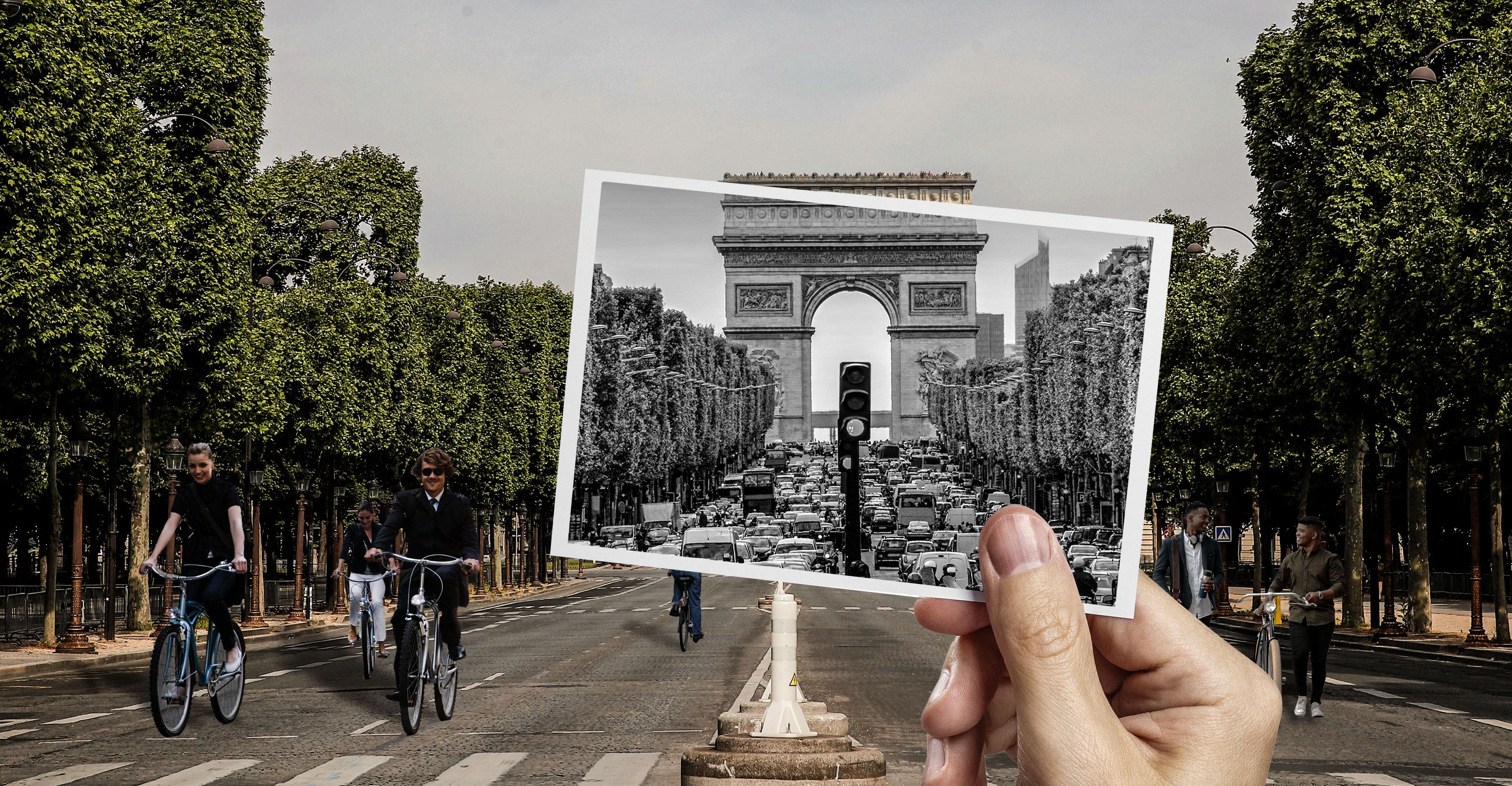 In front of the Arc de Triomphe, a hand holds a black-and-white photo of the monument, while bikers traverse the street lanes nearby.