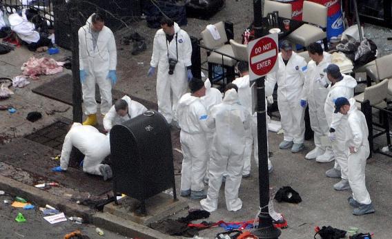 Investigators work the crime scene on Boylston Street following Monday's bomb attack at the Boston Marathon.