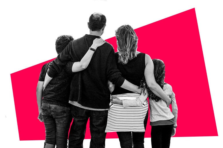 Family of four hugging and facing away.