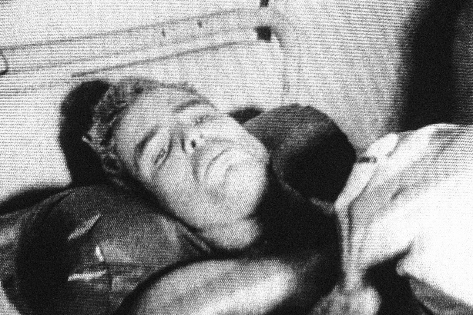 Grainy black and white photo of young McCain on a hospital bed