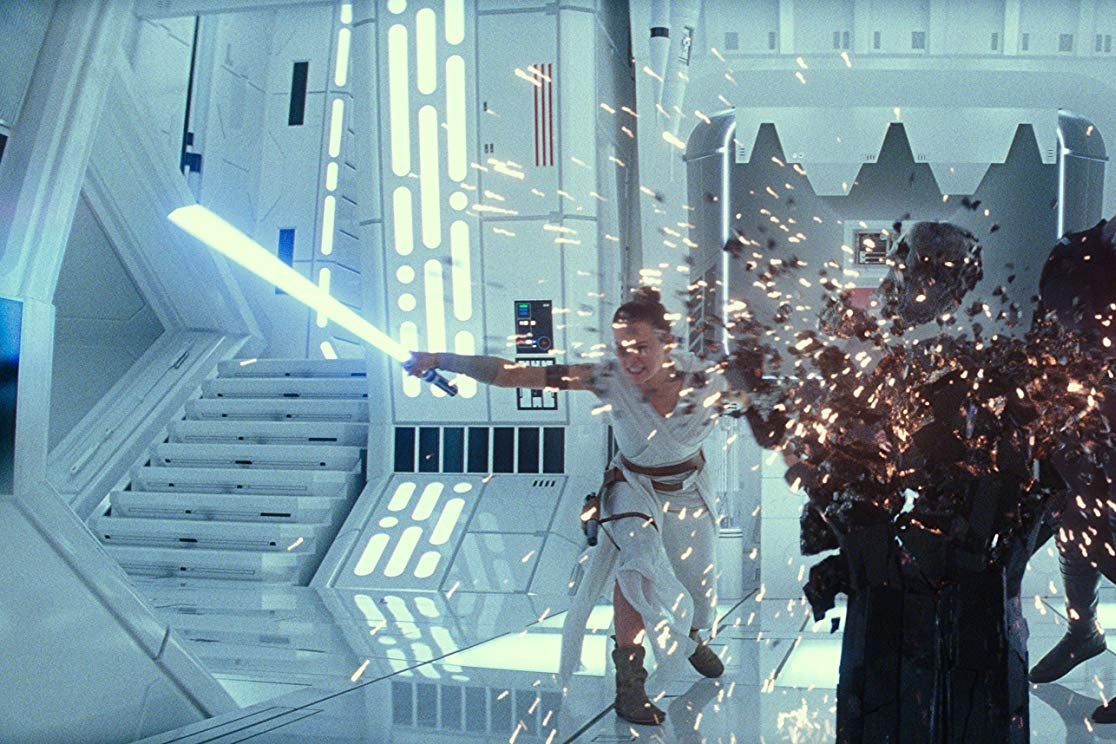 Alt text: Rey and Kylo Ren bash a big black podium with their laser-swords.