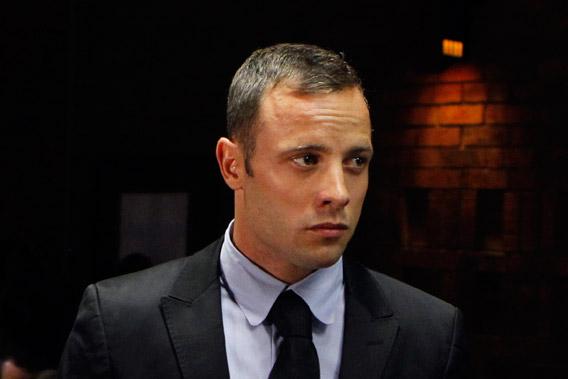 Oscar Pistorius stands in the dock during a break in court proceedings at the Pretoria Magistrates court February 20, 2013.