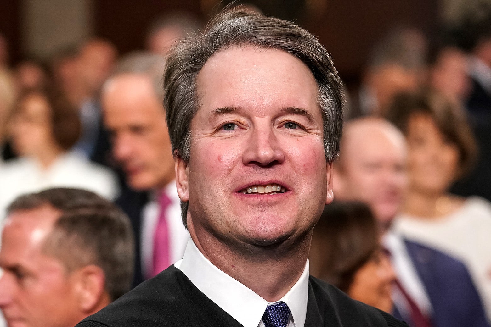 Brett Kavanaugh looking up and smiling.
