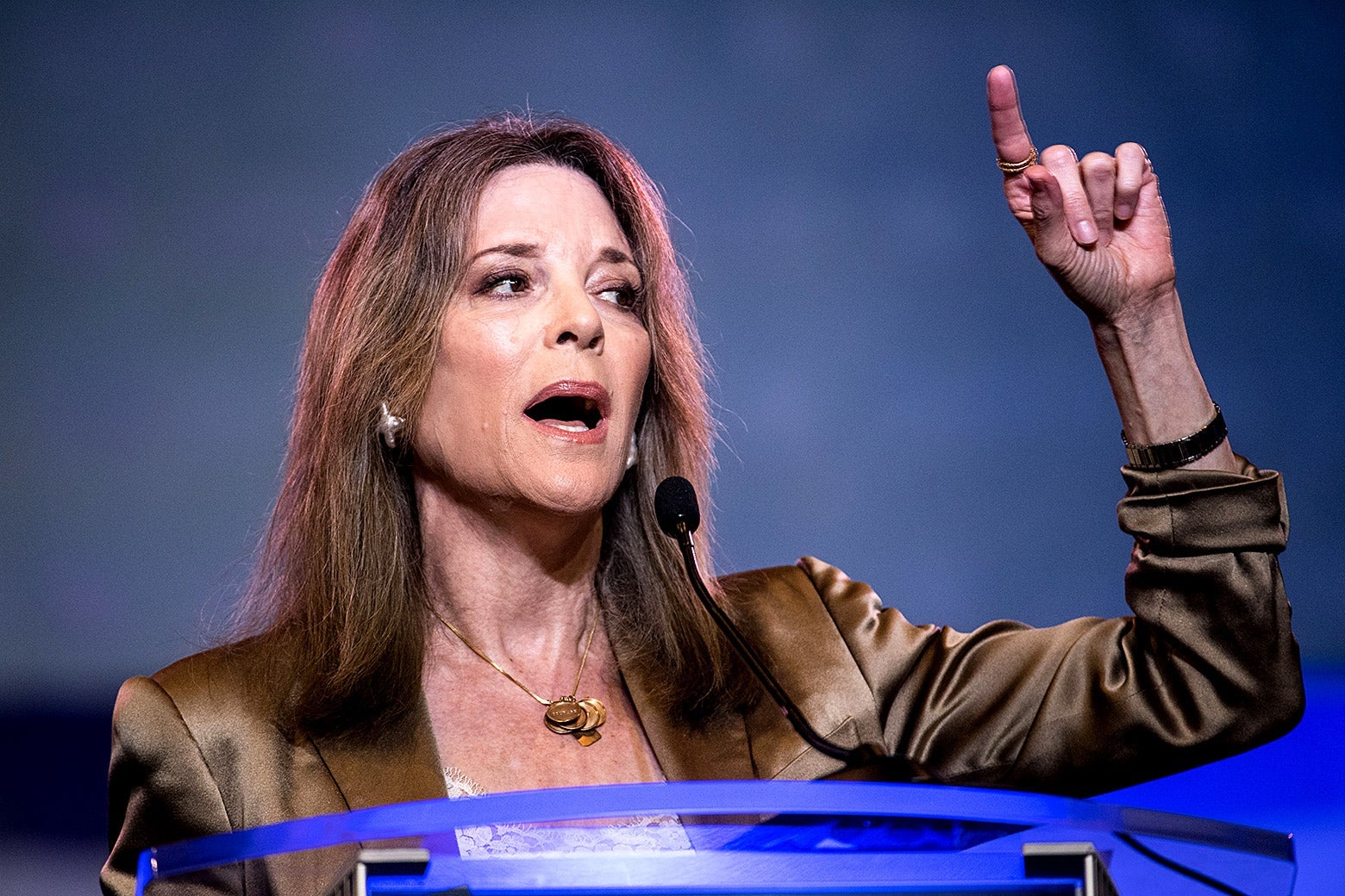 Marianne Williamson gestures while speaking from a podium.