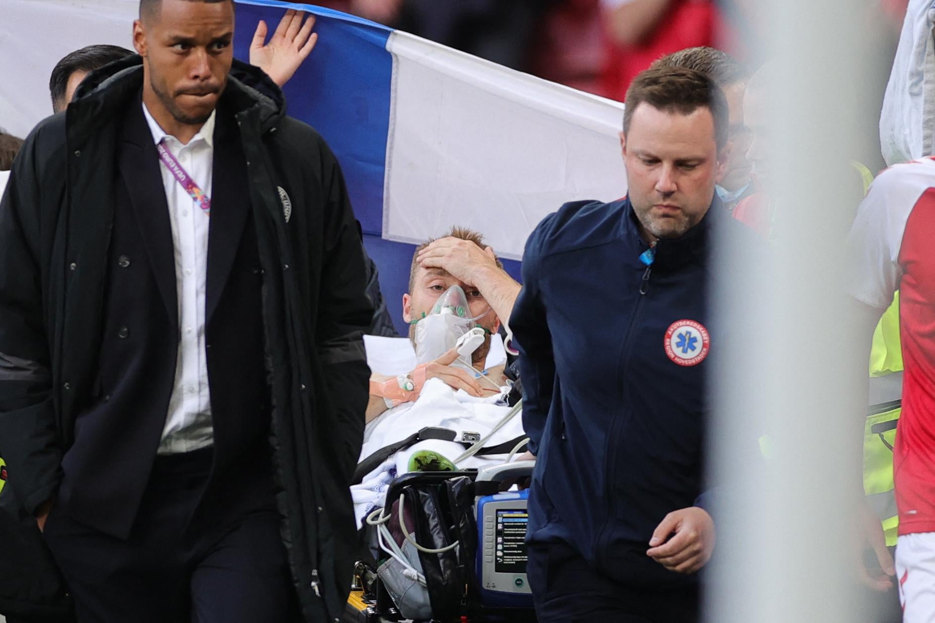 Denmark’s midfielder Christian Eriksen (C) is evacuated after collapsing on the pitch during the UEFA EURO 2020 Group B football match between Denmark and Finland at the Parken Stadium in Copenhagen on June 12, 2021.