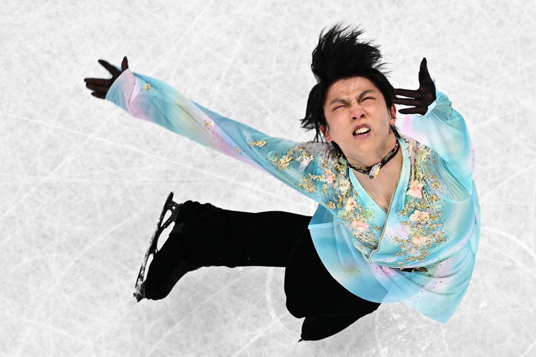Hanyu spinning on the ice, his arms outstretched