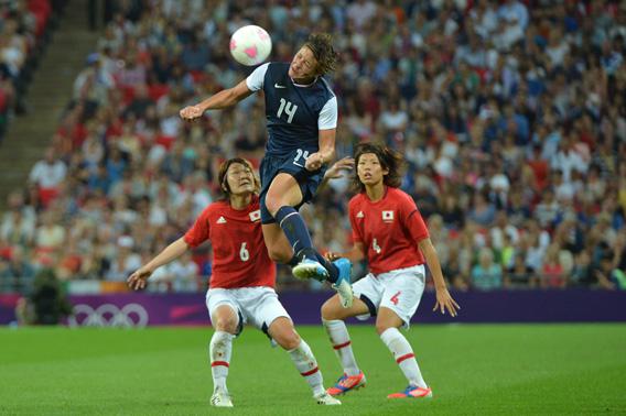 United States's forward Abby Wambach fights for the ball with midfielder Mizuho Sakaguchi and defender Saki Kumagai during the final of the women's football competition of the London 2012 Olympic Games.