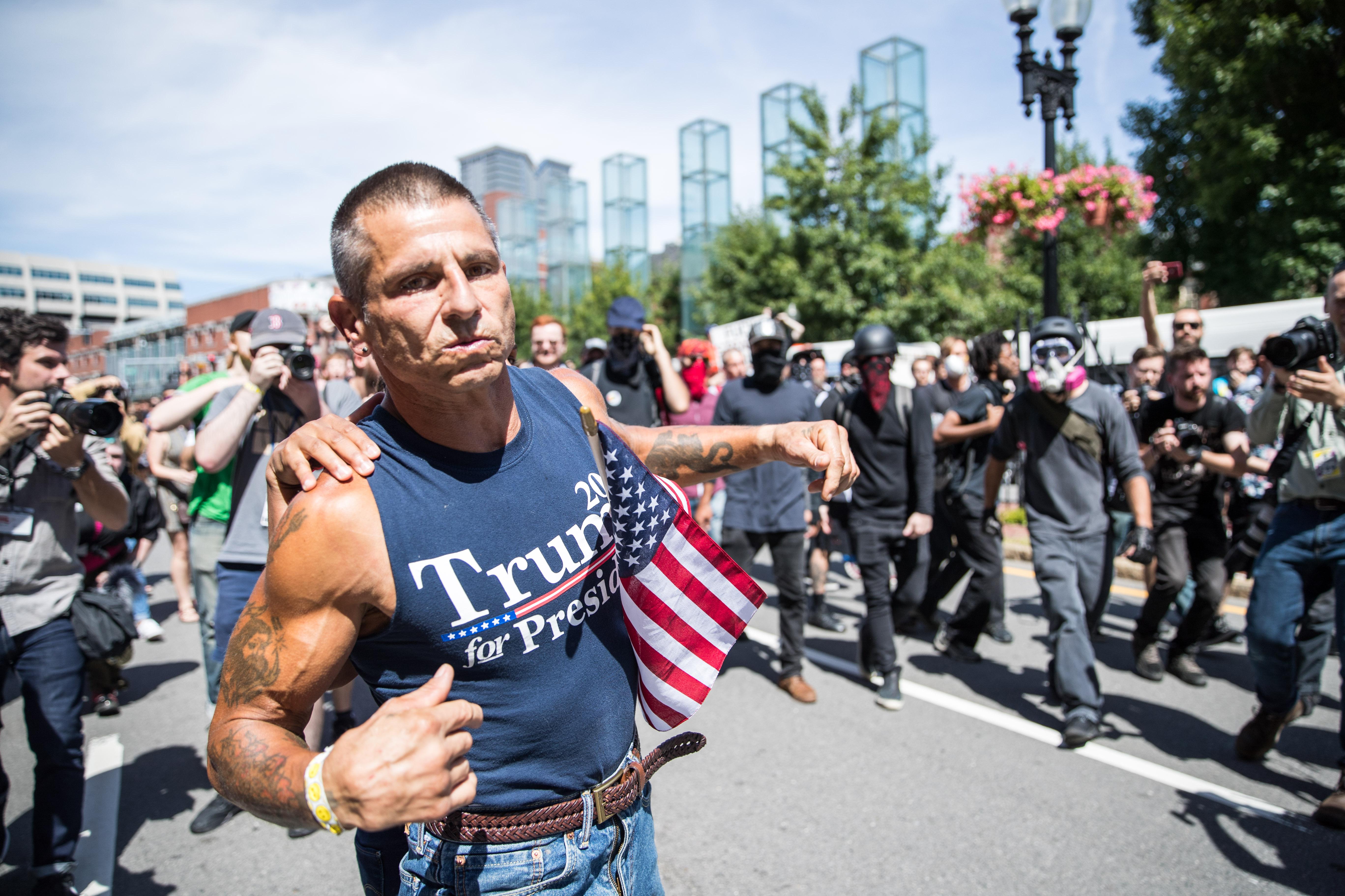 A participant of the Boston Straight Pride Parade is pushed away from counter protesters after an altercation on August 31, 2019 in Boston, Massachusetts. 