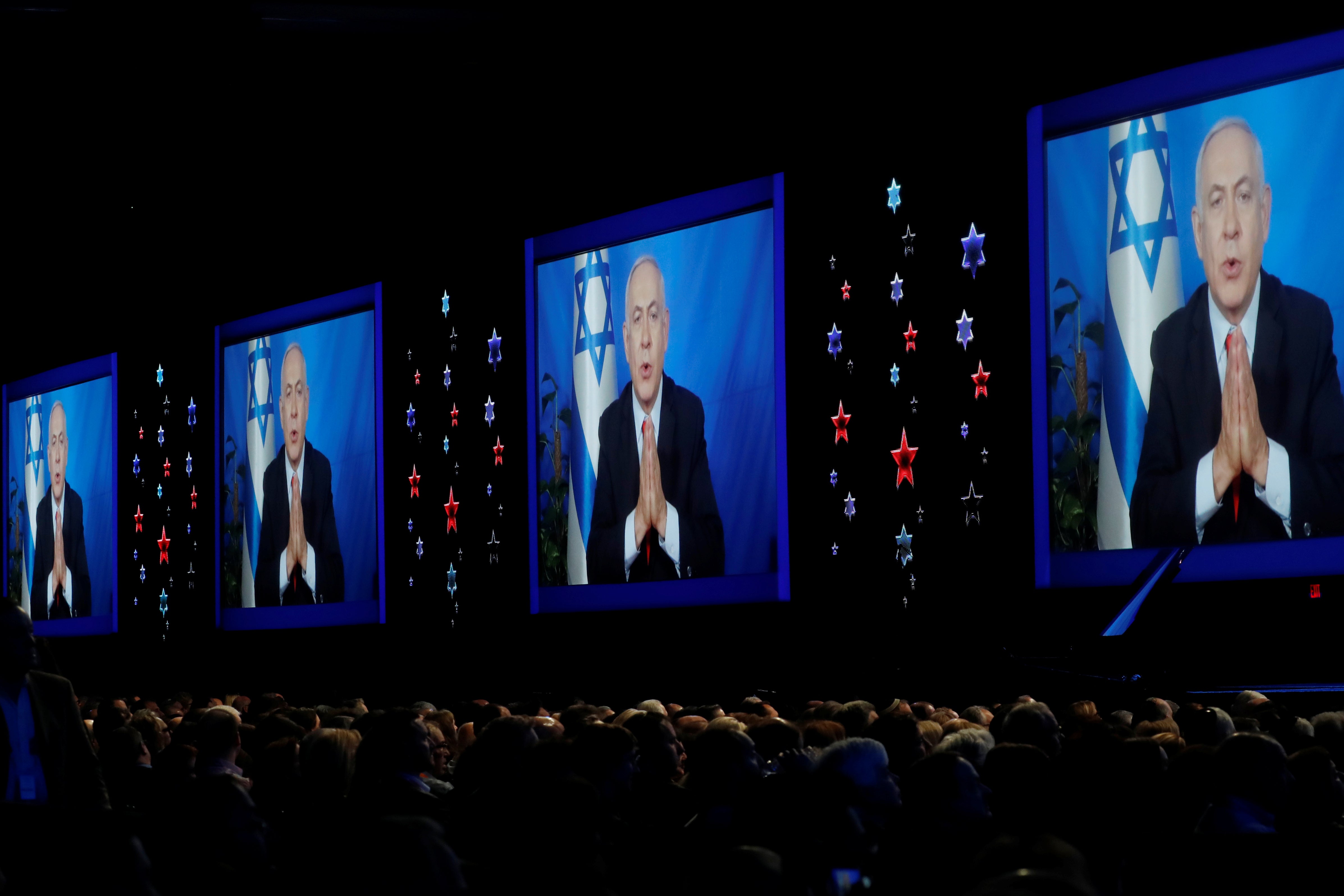 Speaking via satellite feed, Israeli Prime Minister Benjamin Netanyahu addresses AIPAC's conference in Washington on Tuesday.
