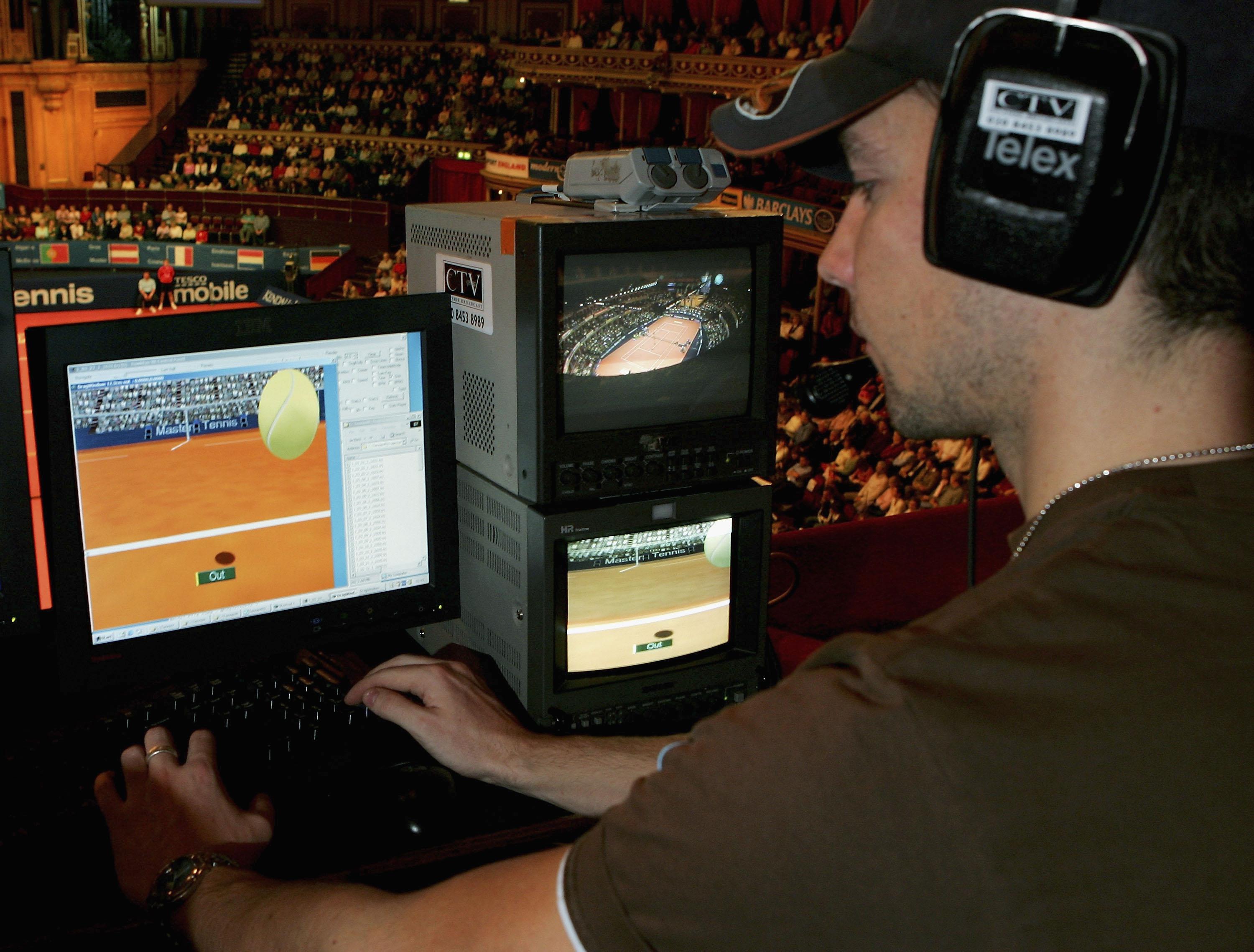 A technician watches screens with the Hawk-Eye system during the Masters Tennis tournament