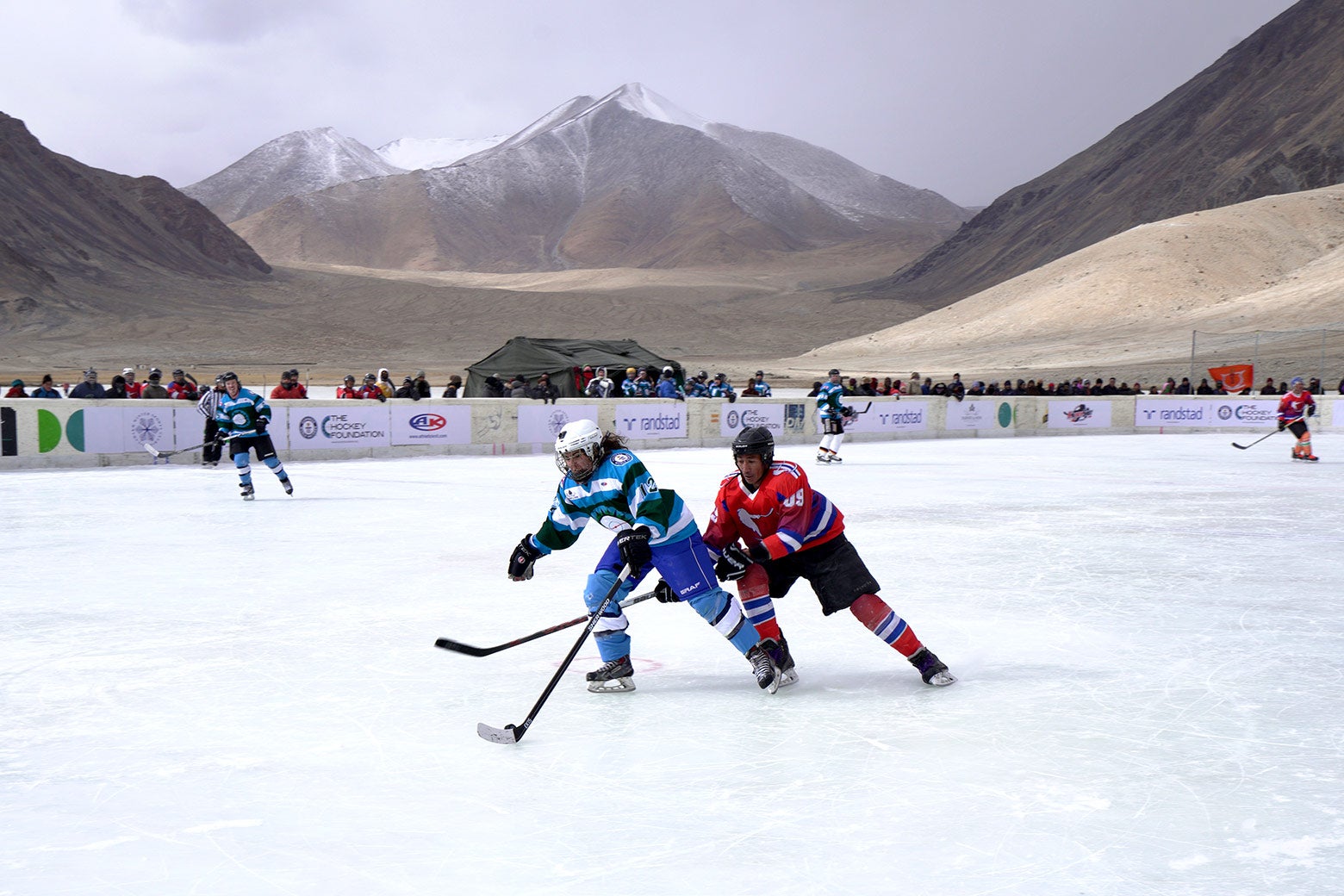 The Himalayas loom over the Olympic-size hockey rink in Chibra Kargyam.