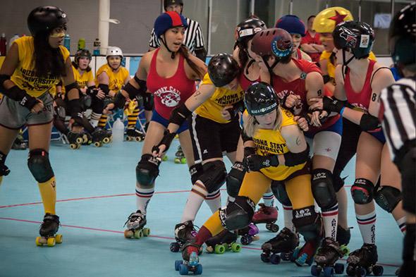 The author (crouching in the foreground) and her Arizona State teammates take on the University of Arizona in a historic college roller derby match.