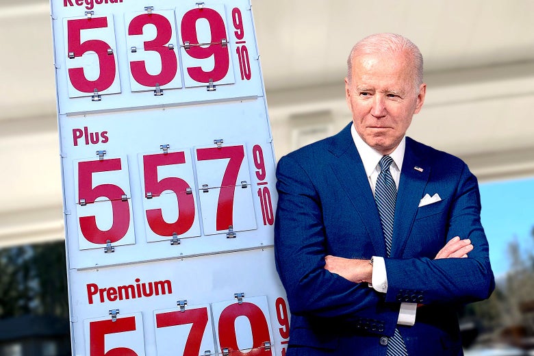 Joe Biden is seen crossing his arms next to a board showing gas prices above $5.