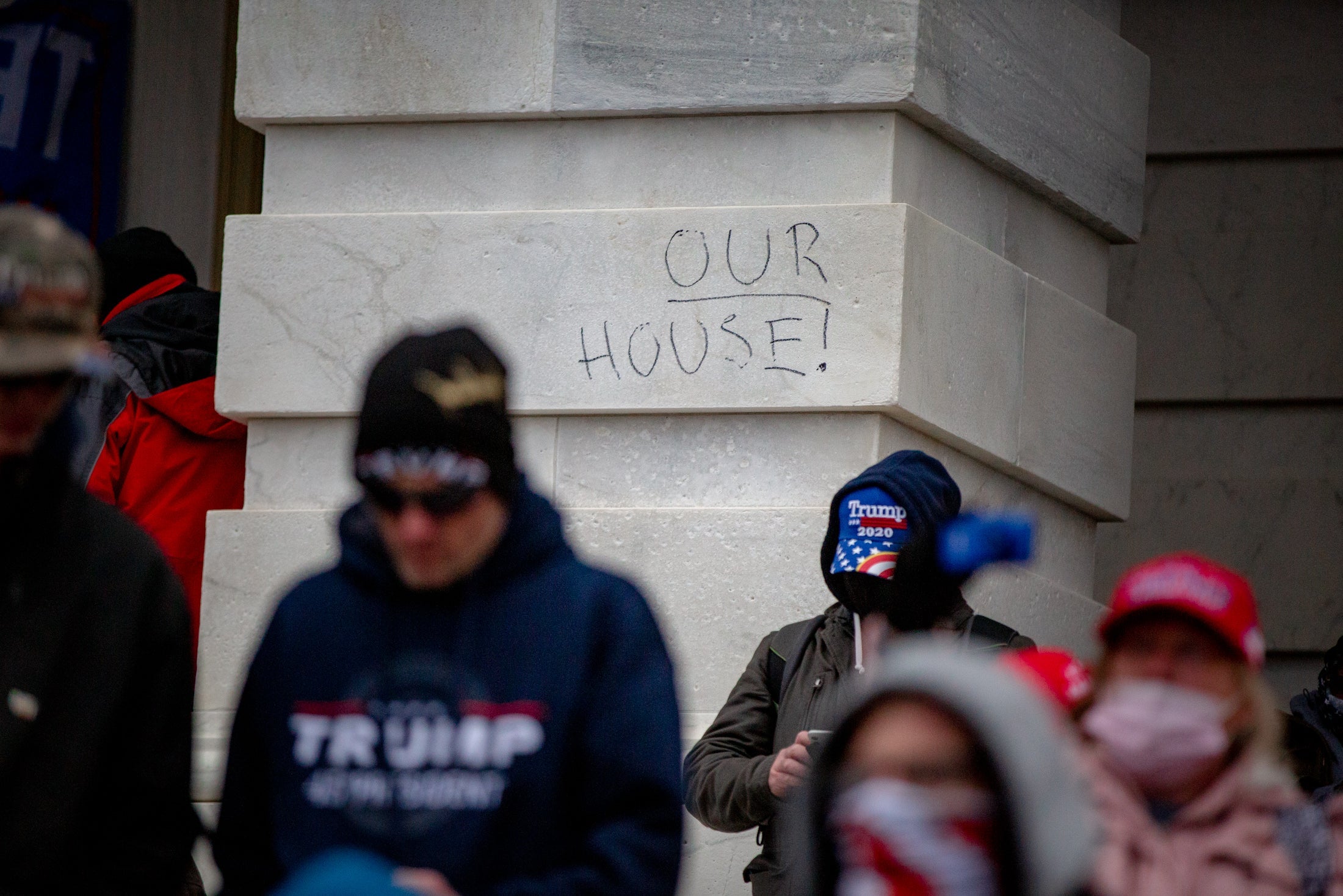 Graffiti outside the Capitol reads "OUR HOUSE!"