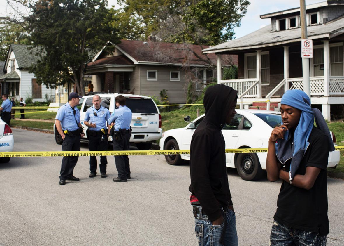 A crowd gathers at the site of an officer involved shooting on Sunday, Oct. 1st. Officers shot and critically wounded a 14yr old boy, who they claimed had fired at them first.
