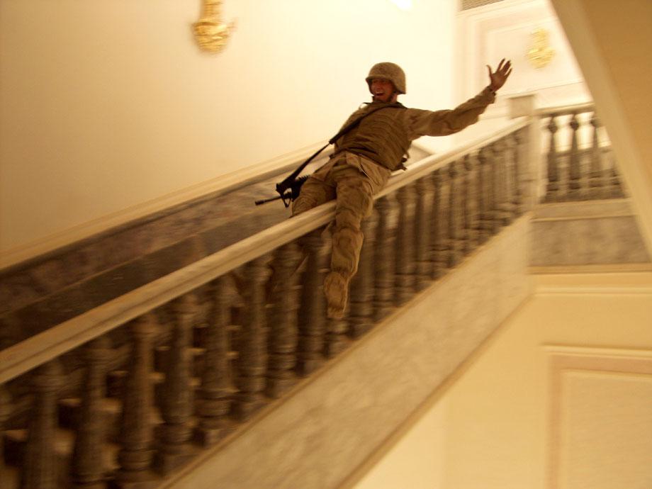 TIKRIT, Iraq—In Saddam's hometown, a U.S. Marine slides down a marble handrail in one of the dictator's extravagant palaces. The residence contained carpets worth hundreds of thousands of dollars and at least one golden toilet. Tikrit was the last major city to fall to Allied forces during the invasion, and, despite fighting that continued through Iraq, Marines celebrated victory, April 14, 2003.