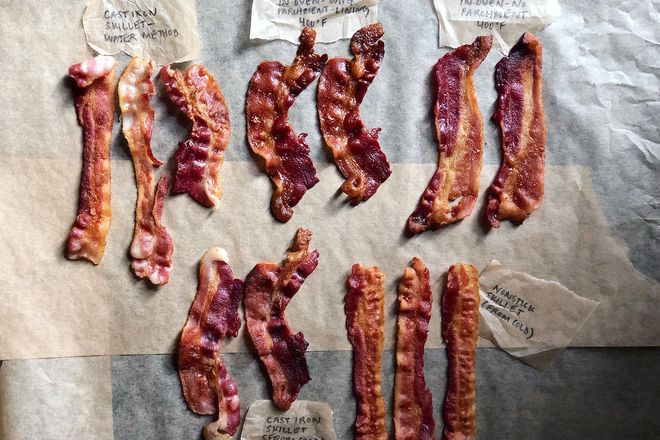 Five groupings of bacon on a table. Some are straight while others are curly.