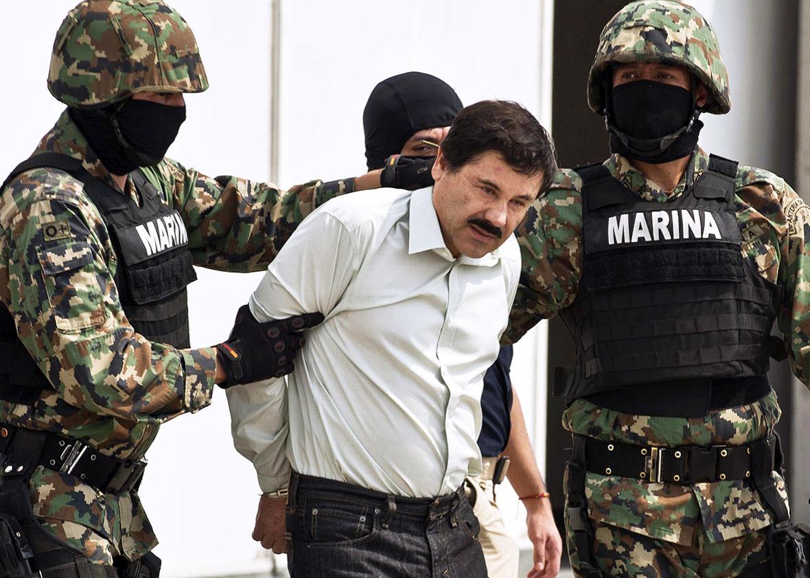 Mexican drug trafficker Joaquin Guzman Loera aka "el Chapo Guzman", is escorted by marines as he is presented to the press on February 22, 2014 in Mexico City. 
