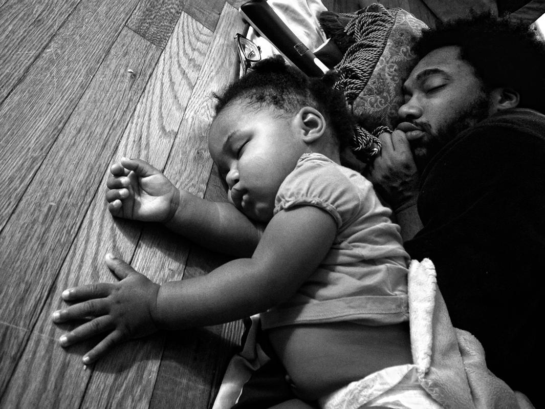 Camp Lejeune, North Carolina, 2012. Anthony Francis and daughter Tena fall asleep in the living room. 