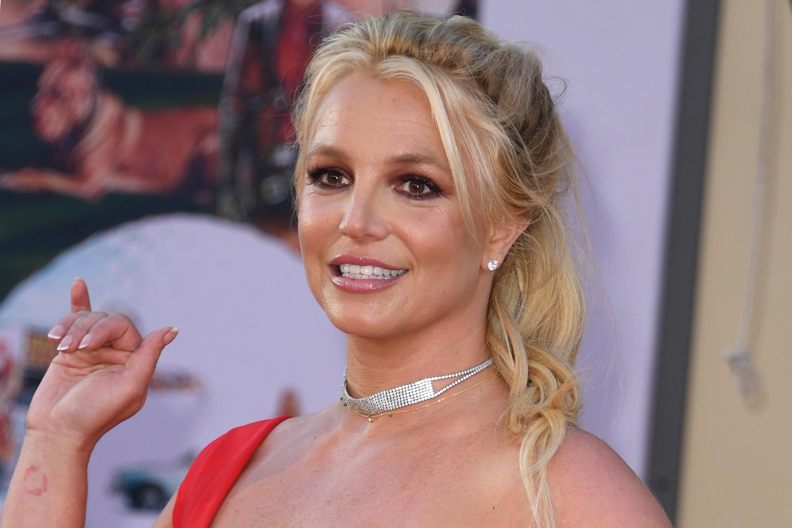 Britney Spears smiles and waves at a premier.