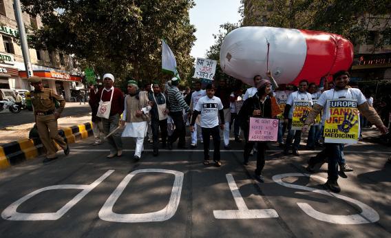 HIV and AIDS campaigners carry a giant balloon in the shape of a pill during a protest rally in New Delhi on Feb. 10, 2012, against the negative impact of the E.U.-India Free Trade Agreement on affordable medicines across developing countries