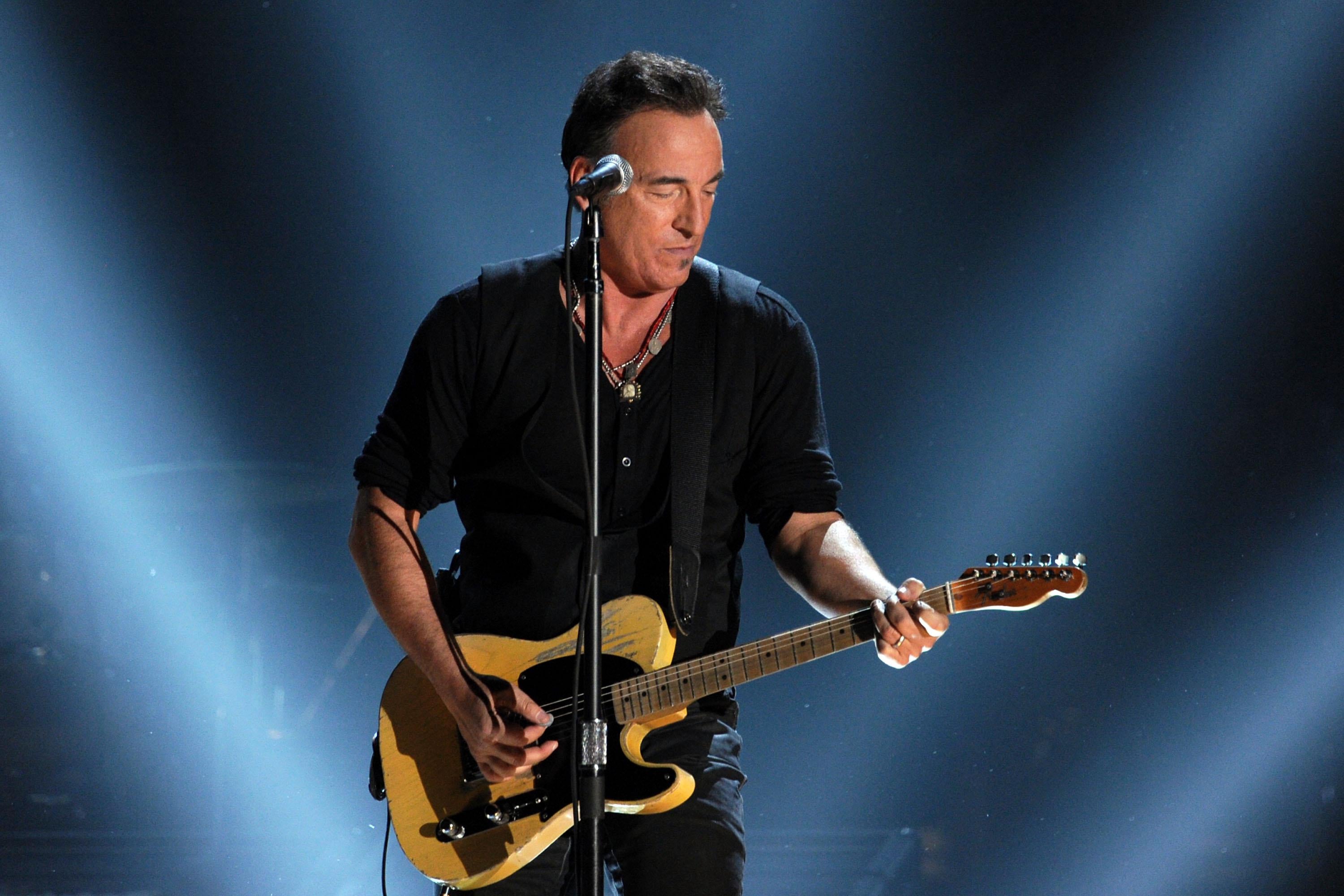 Springsteen plays guitar onstage.