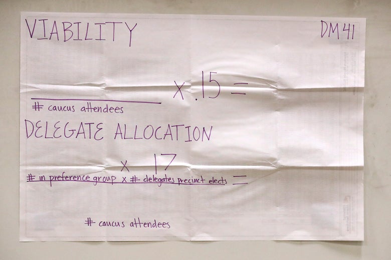 A poster explains the allocation of delegate count at a caucus at Roosevelt High School February 03, 2020 in Des Moines, Iowa. 